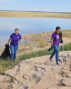 Two students pick up trash near Santa Rosa Lake, N.M., as part of a National Public Lands Day event there Sept. 28, 2024. Two students pick up trash near Santa Rosa Lake, N.M., as part of a National Public Lands Day event there Sept. 28, 2024.